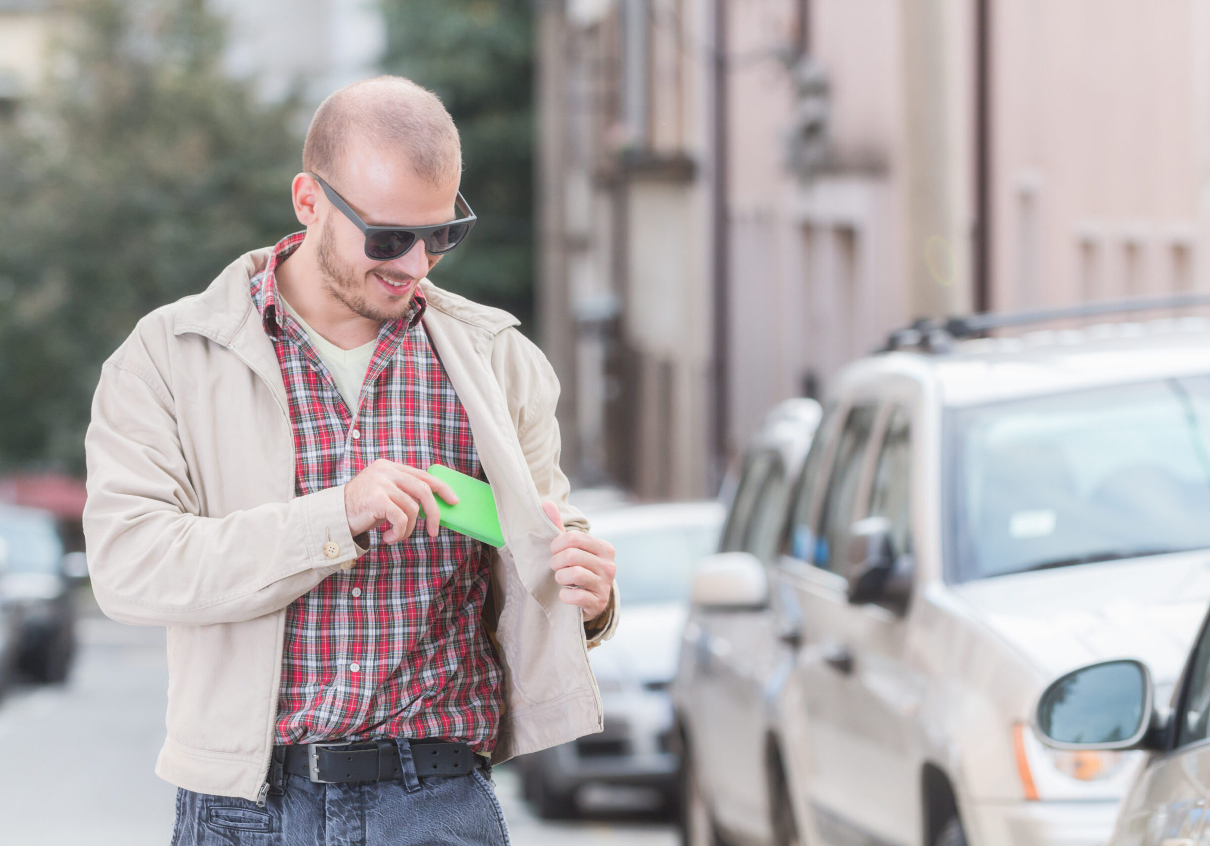 Man taking out / putting in cellphone from / into the pocket.